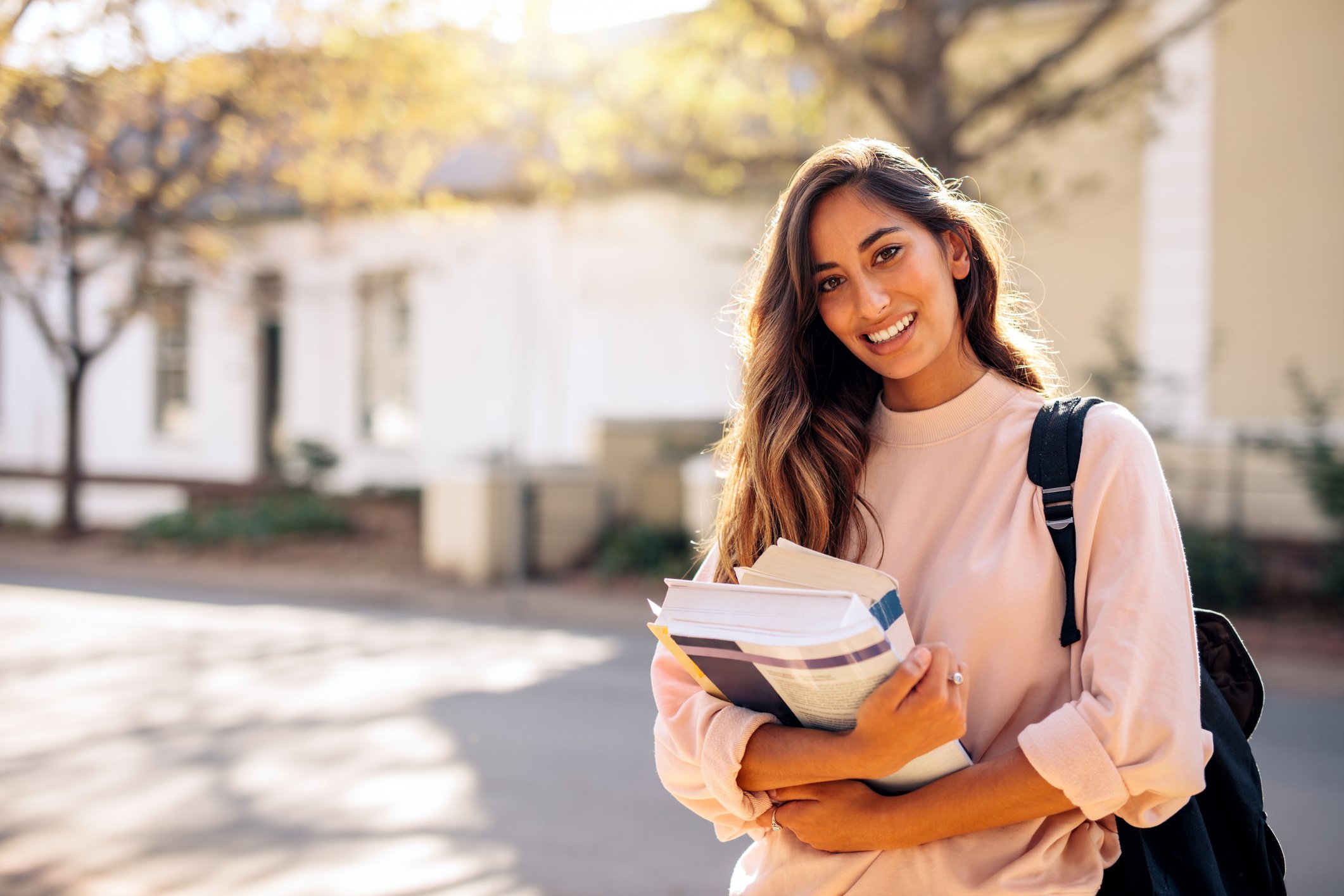 Female College Student with Books Outdoors